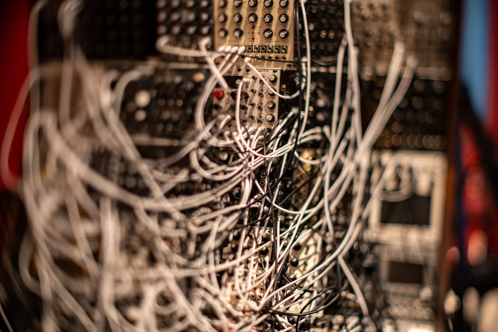 Close-up of a Eurorack modular synthesizer with patch cables and control knobs.