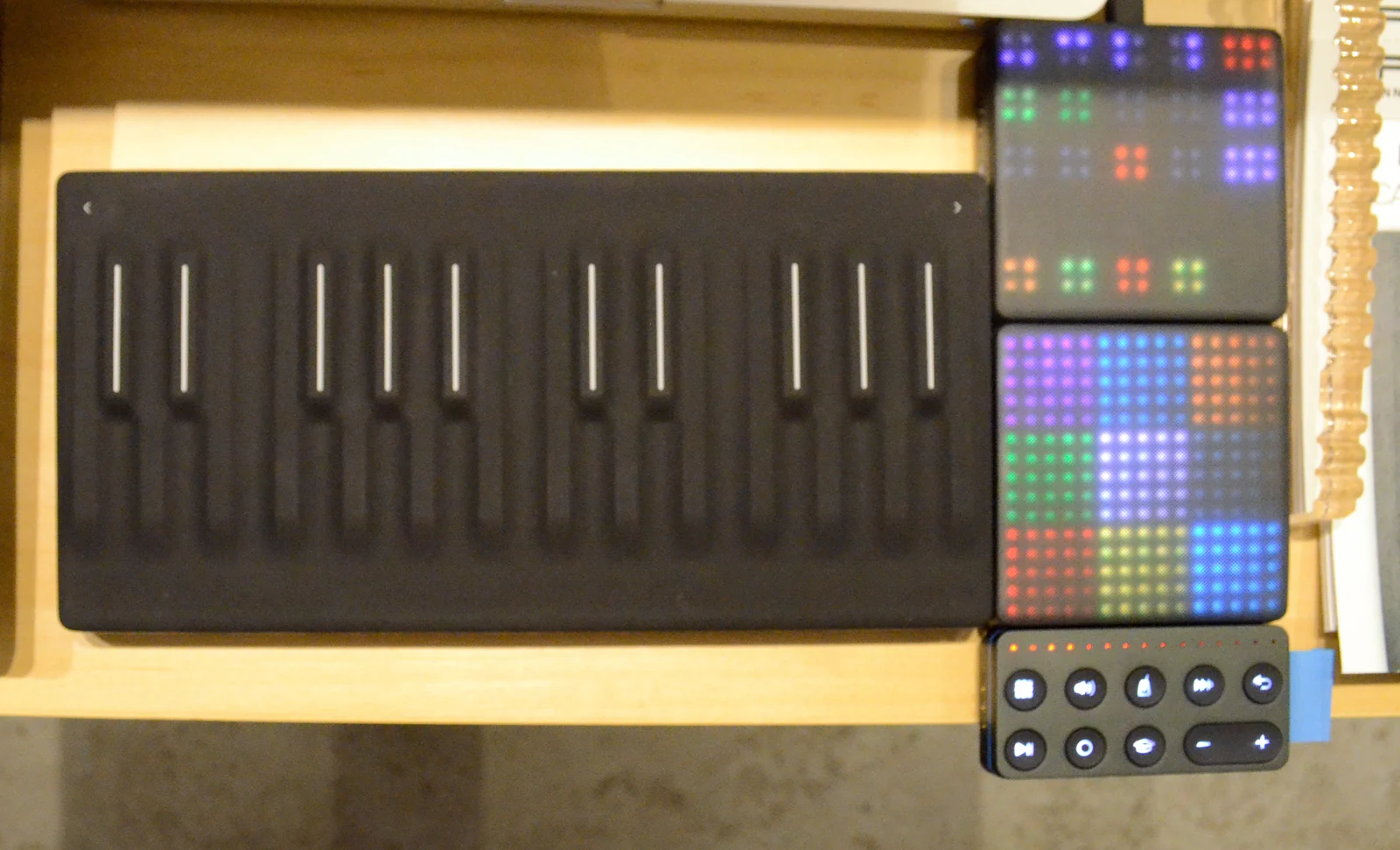 ROLI Seaboard Block, Loop Block and two Lightpad Blocks on a demonstration table.